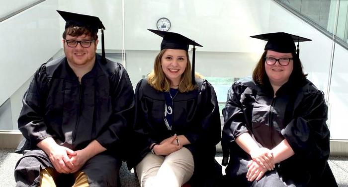 Three A&M-Commerce students pose for photo in caps and gowns